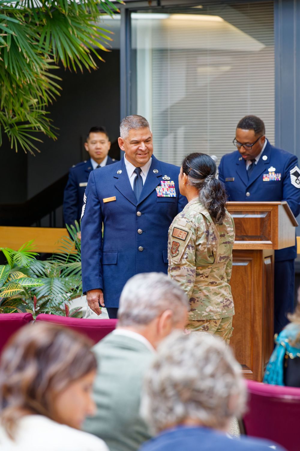 Air Force officer in dress blues receiving recognition from soldier at military retirement ceremony.