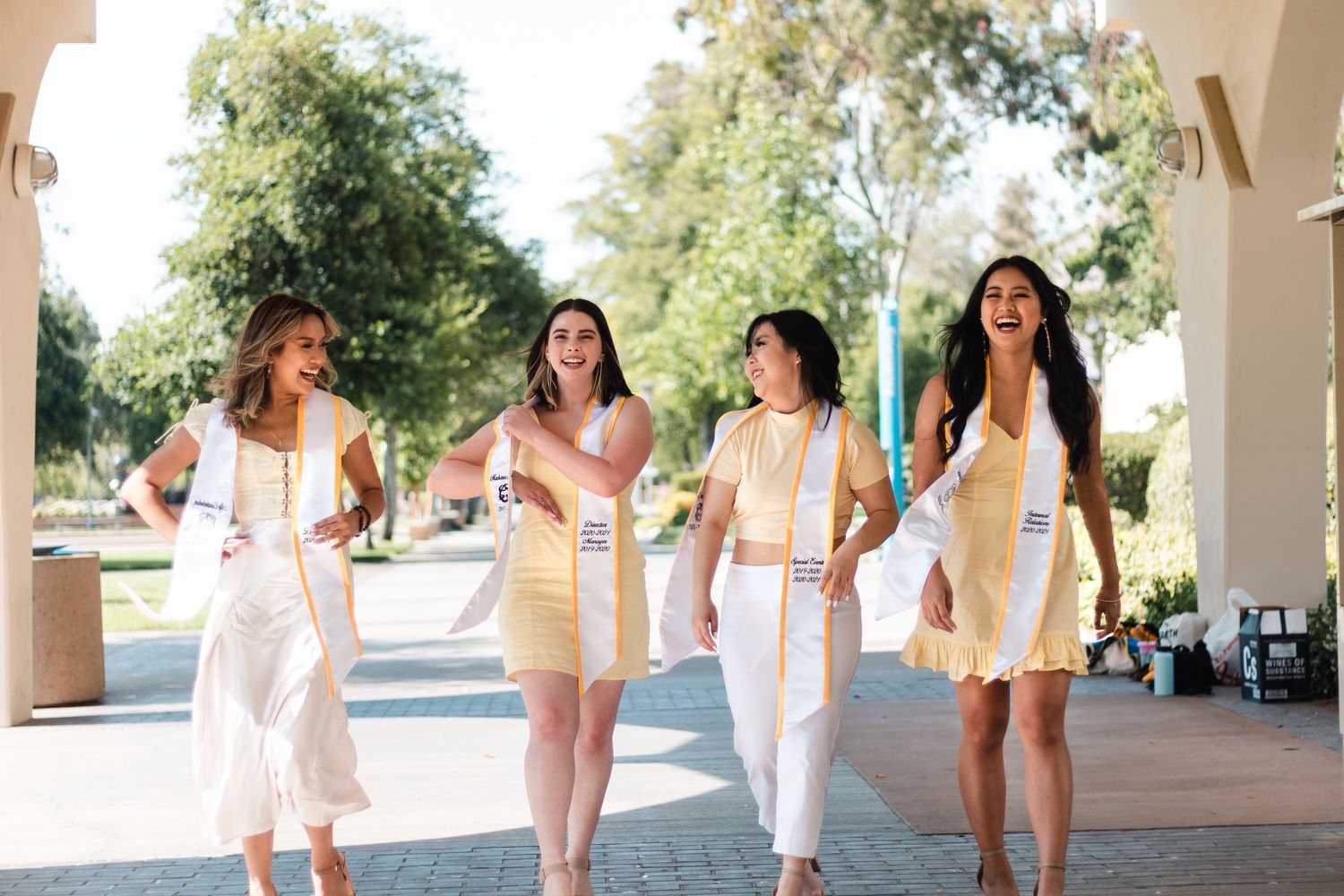 College senior candid walking during graduation photoshoot in Fresno, California