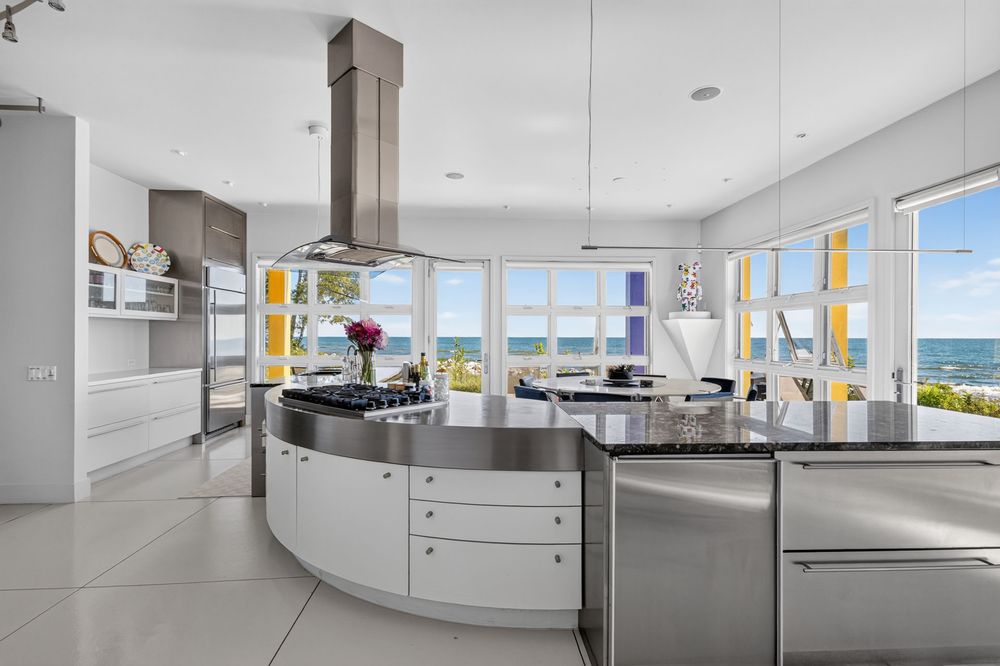 Crayola House kitchen with curved stainless island and rainbow window trim