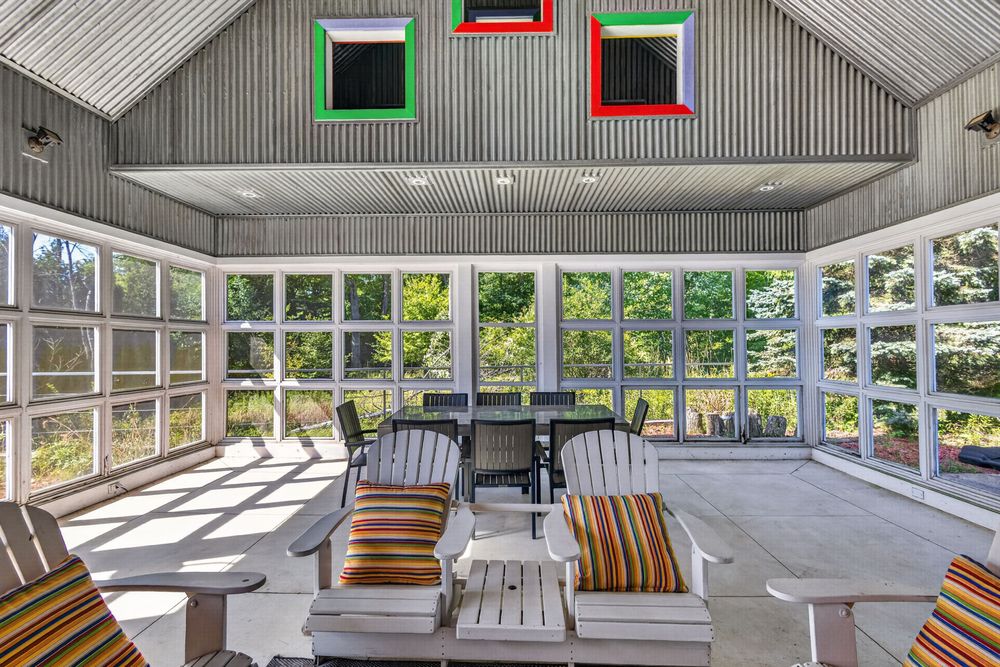 Crayola House sunroom with corrugated metal walls and lake-facing windows