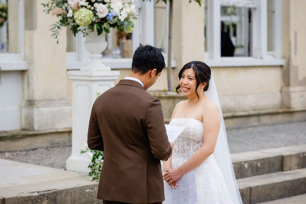 bride and groom at wedding ceremony laughing