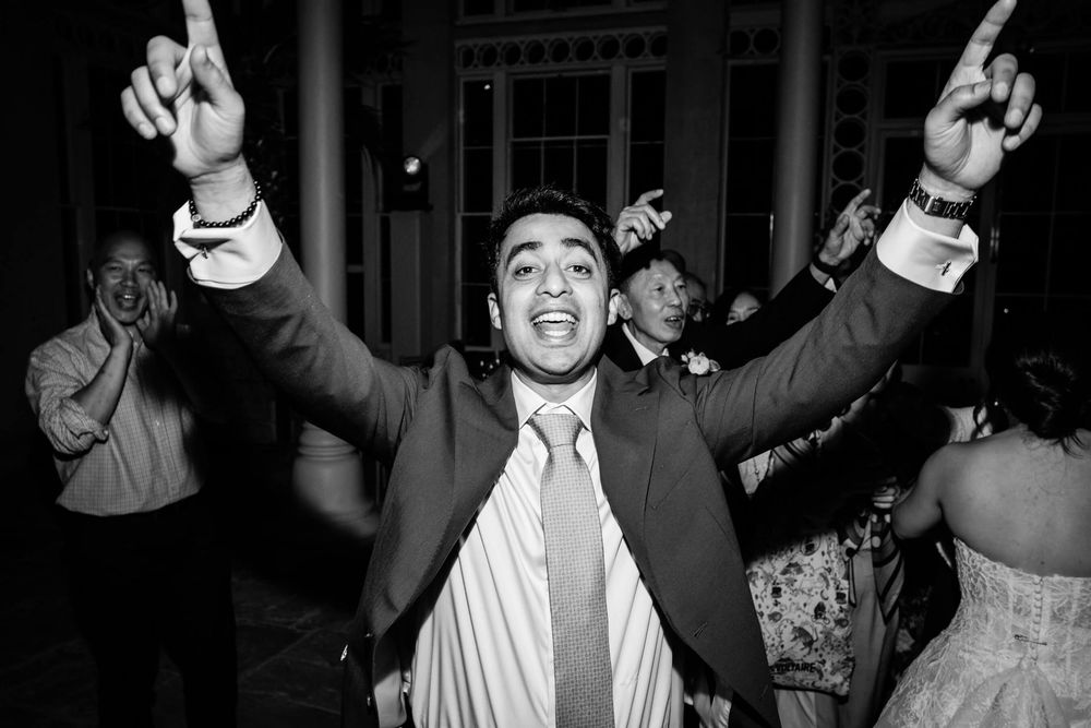 groom celebrates on the dance floor at wedding