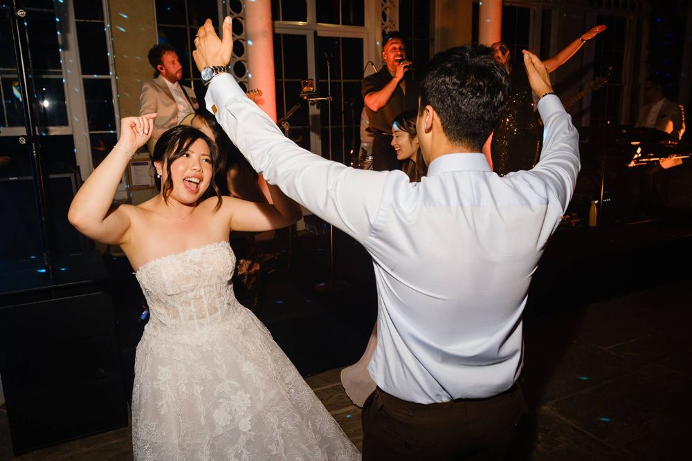 bride and groom having fun on dance floor