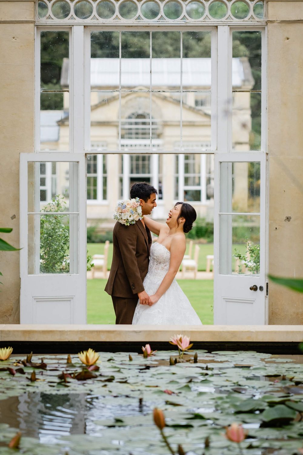 bride and groom laugh at Syon park wedding