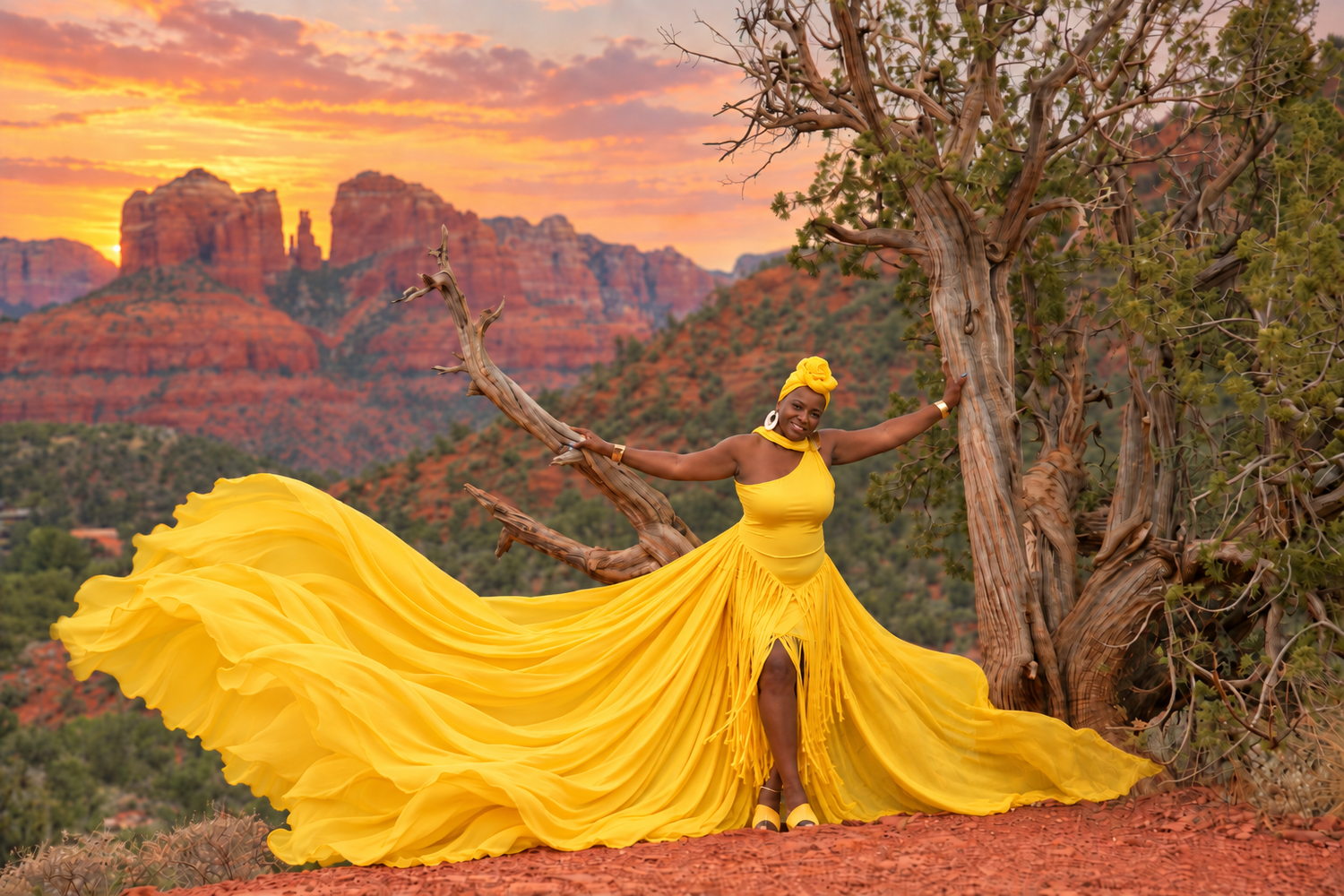 Woman in flowing yellow gown poses dramatically against Sedona red rocks at sunset.