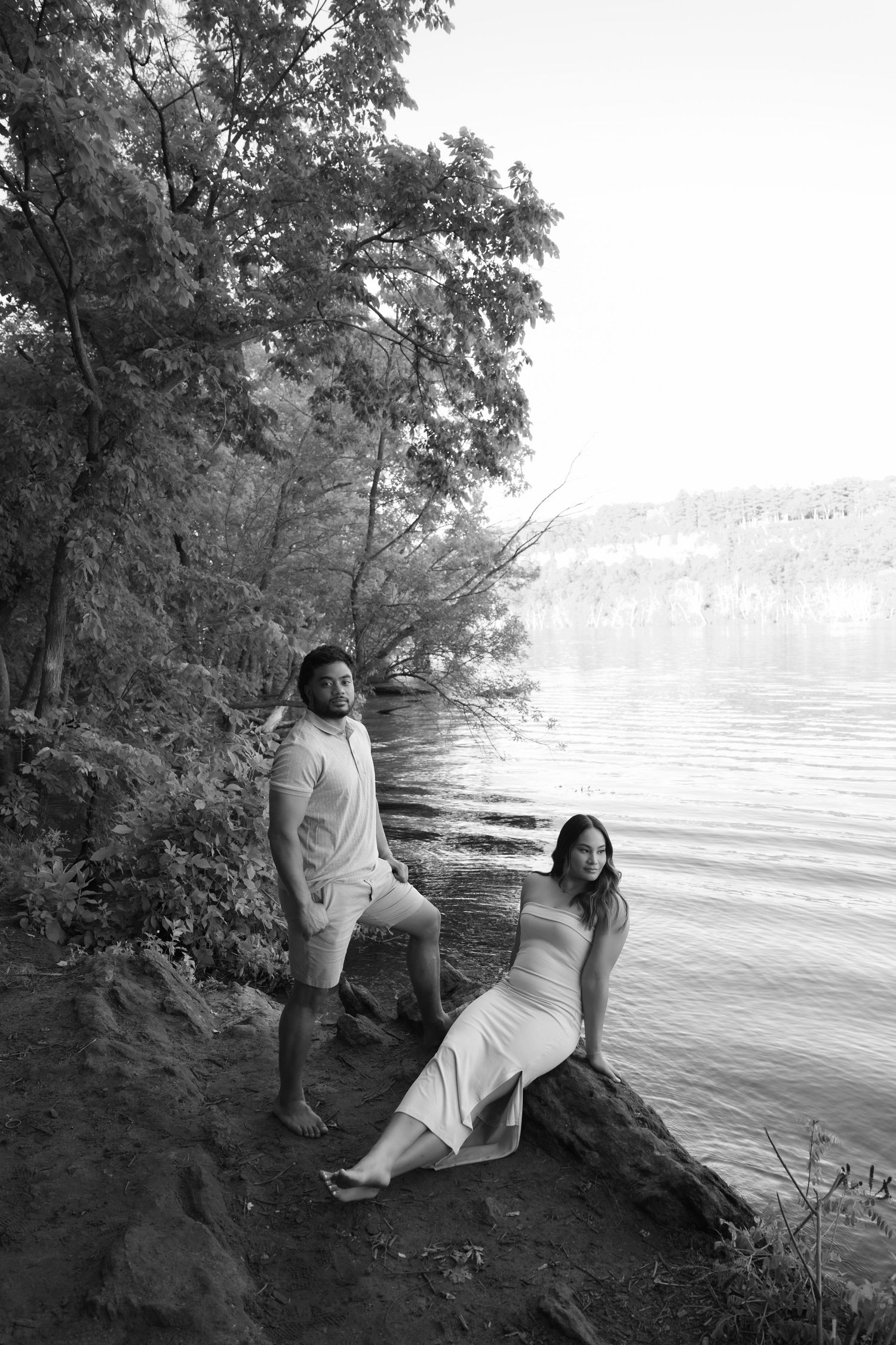 Engaged couple sits near the St. Croix River for an editorial style outdoor engagement session near Stillwater, MN.