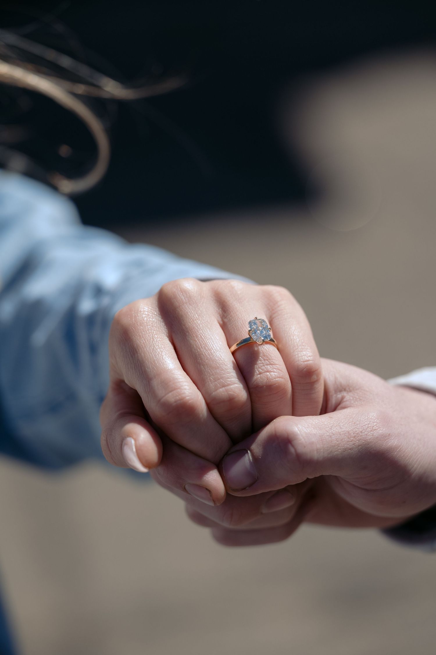 Engaged couple shows off a brand new engagement ring during a proposal near the river in downtown Stillwater, MN.