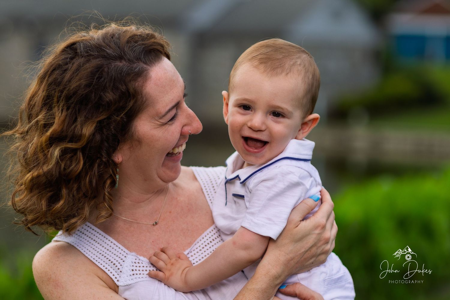 A joyful moment shared between parent and baby during outdoor family photoshoot.