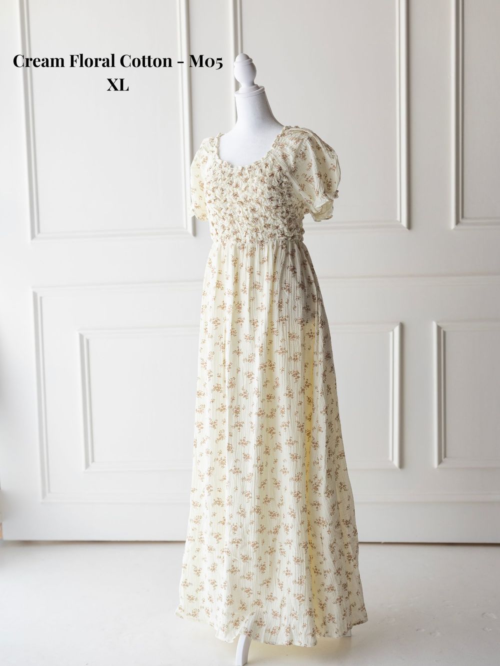 Cream floral cotton sleeveless dress with empire waist and delicate floral pattern shown from multiple angles.