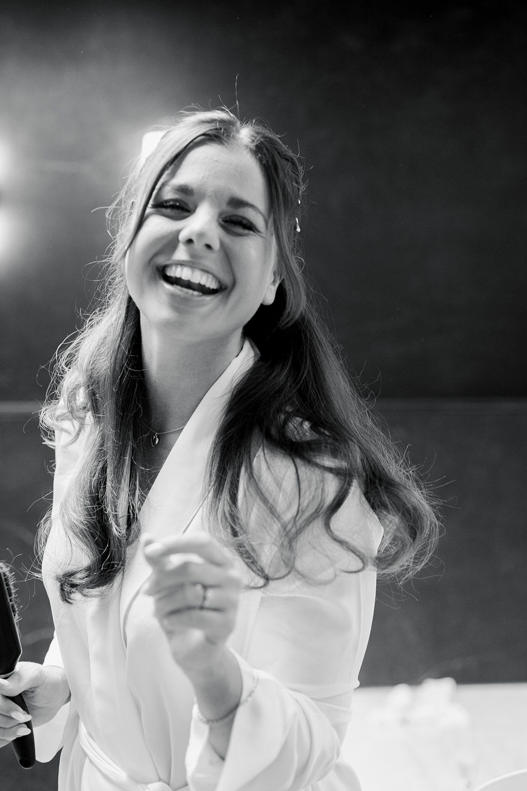 Black and white photo series showing joyful expressions and laughter while wearing a white shirt.