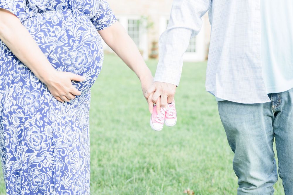 Couple holding hands outdoors wearing coordinated blue and white outfits.