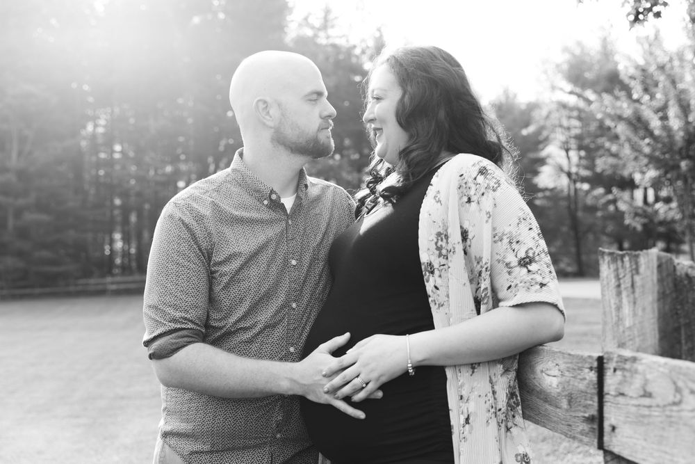 Black and white romantic portraits captured against a rustic fence backdrop.