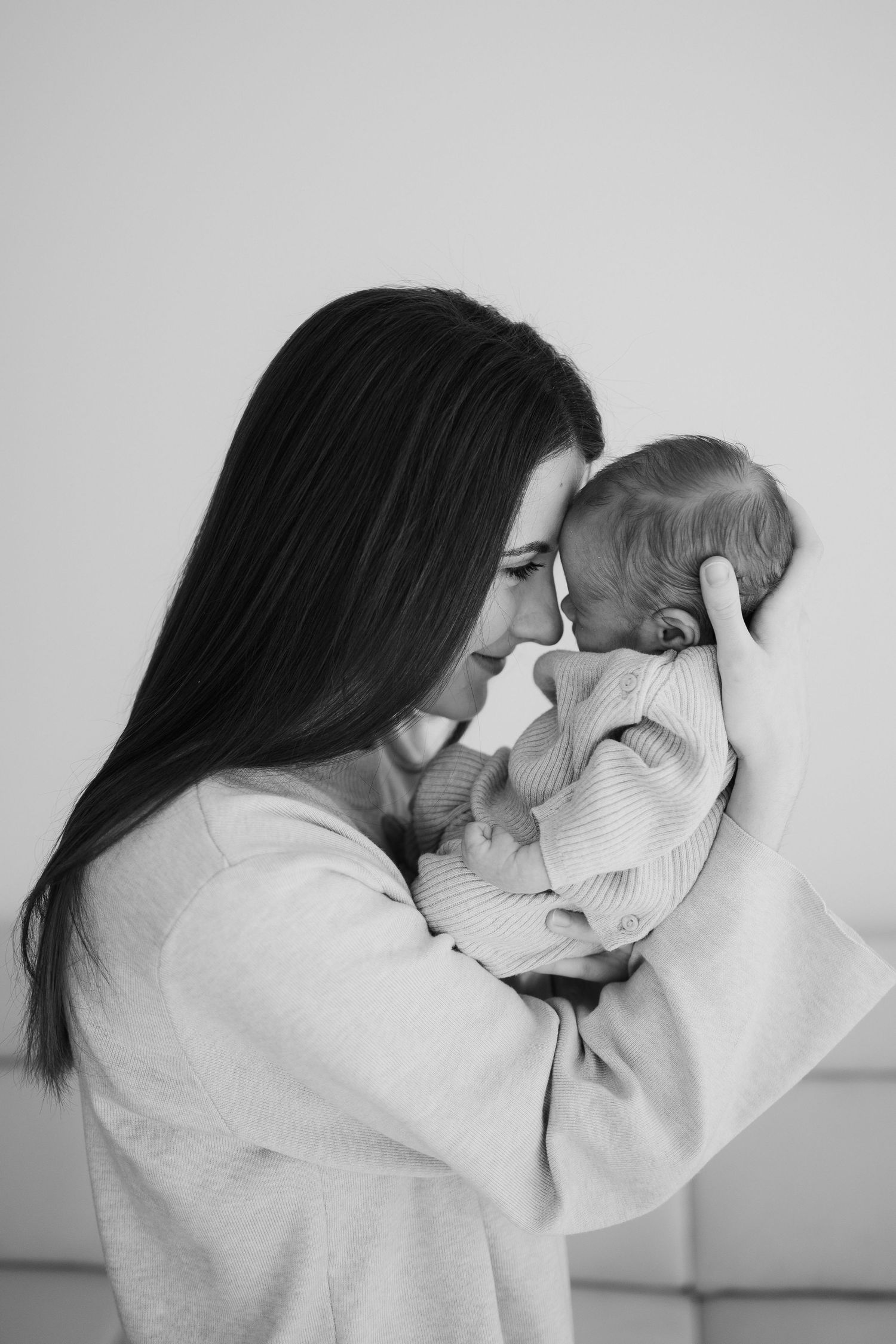 Intimate black and white portrait of couple in matching light sweaters.