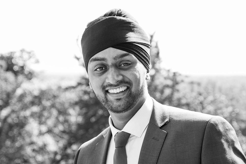 A black and white photo montage showing candid expressions and joyful moments at an outdoor event.