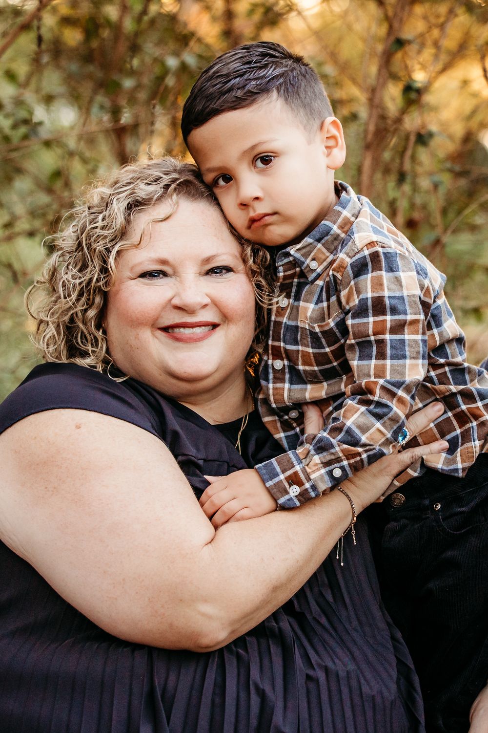A heartwarming outdoor family photoshoot series showing tender embraces and joyful moments between parent and child.