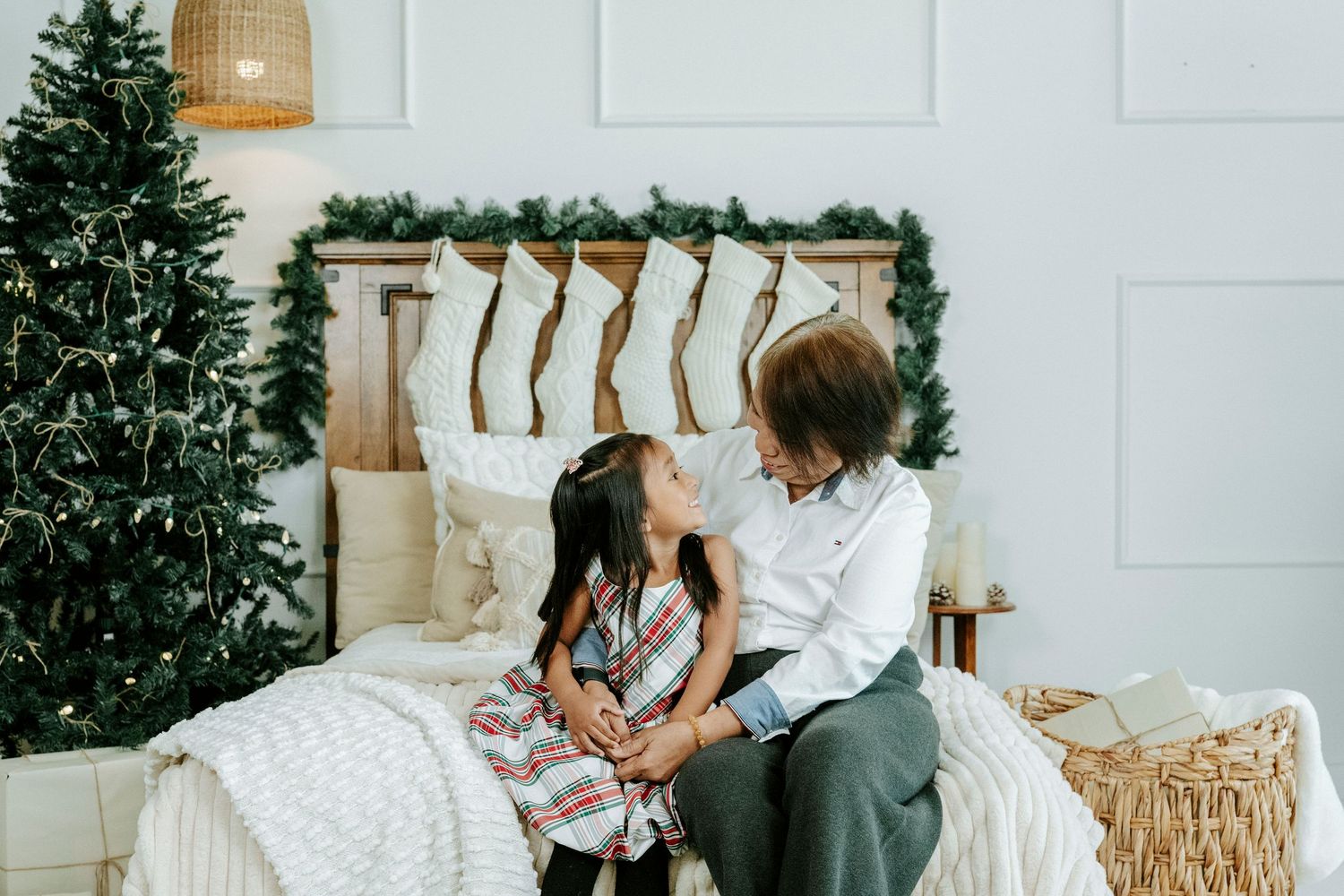 Cozy winter scene with a decorated Christmas tree and warm holiday decor in a bright modern living room.