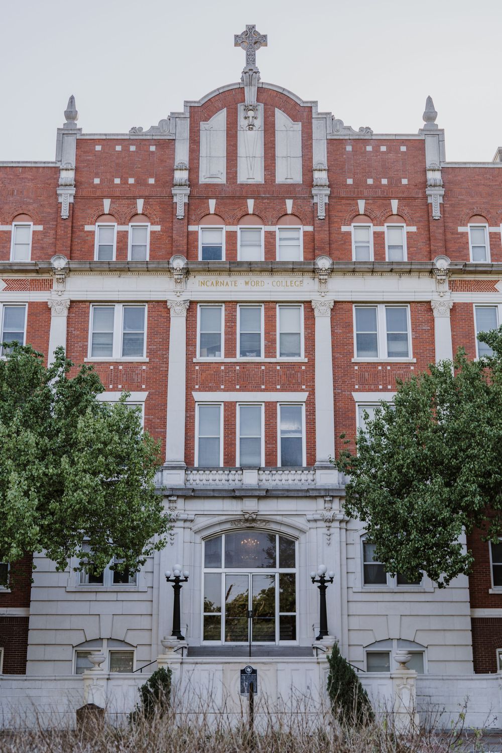 Historic red brick building facade with ornate architectural details and white stone trim.