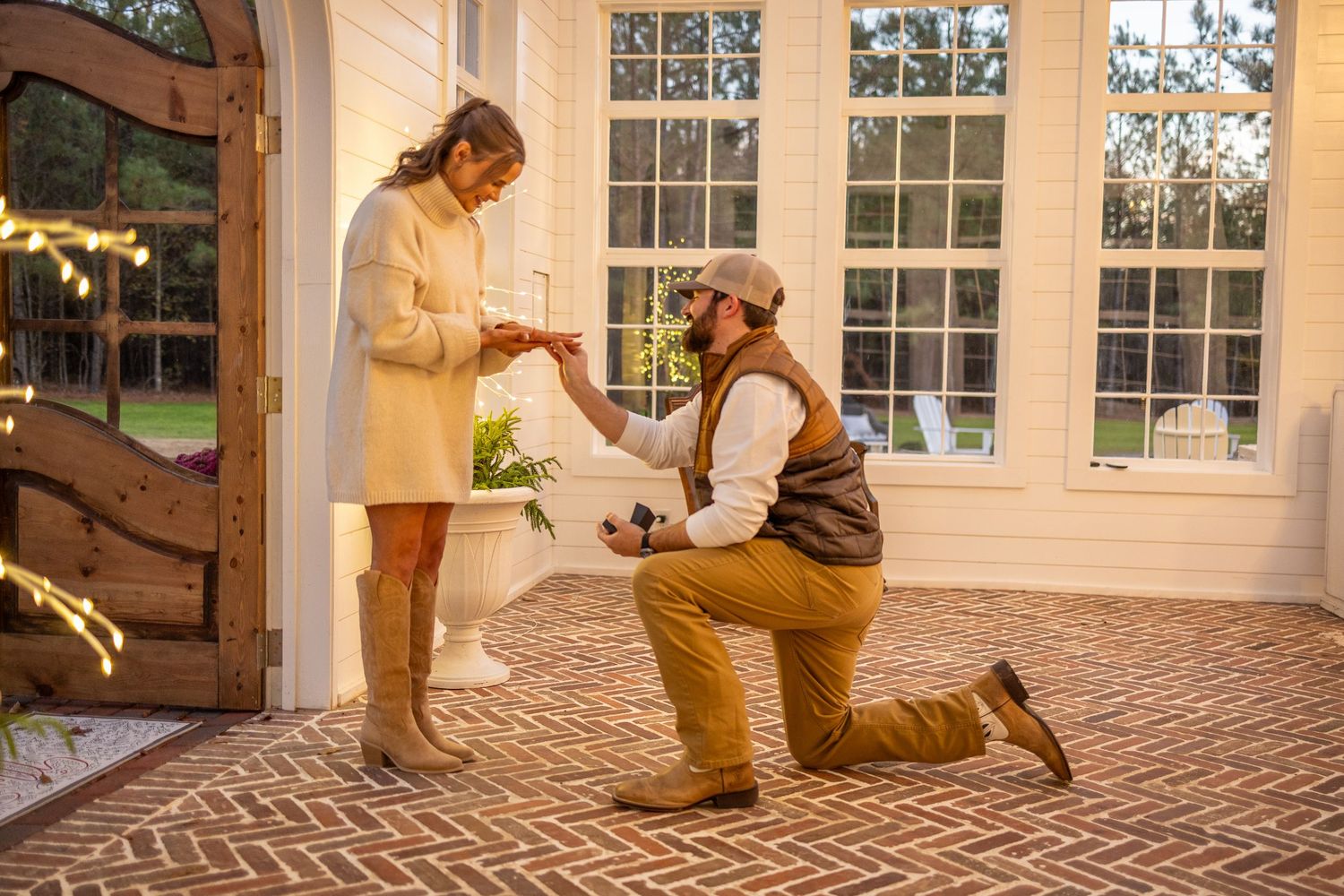 Woman putting ring on after getting proposed to at the English Cottage