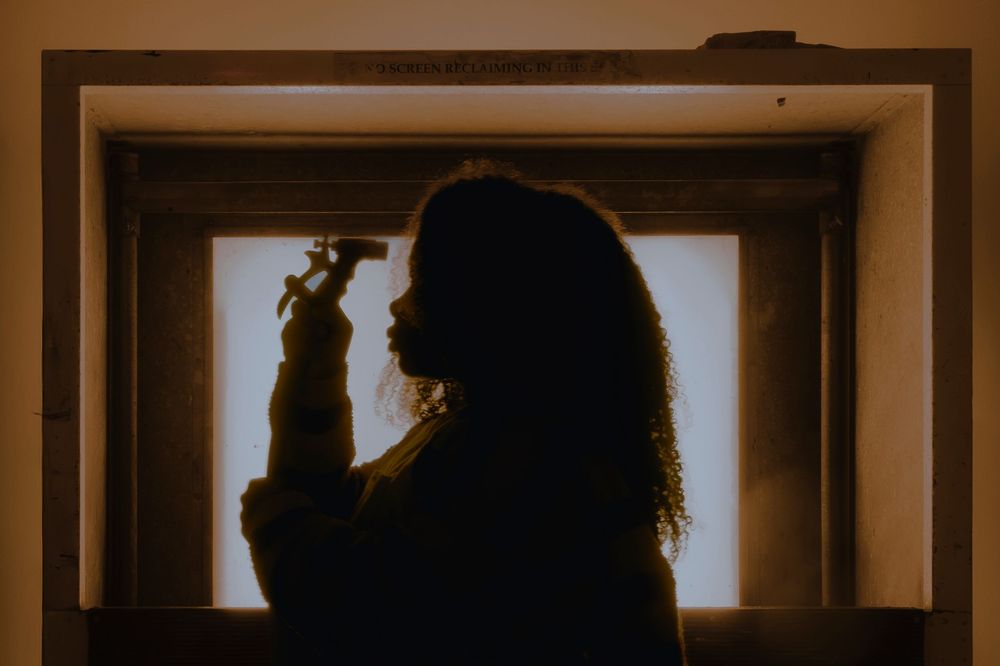 Silhouettes framed in window panels with dramatic backlighting.