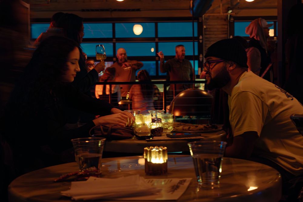 Warm candlelit restaurant interior with tables set for evening dining.