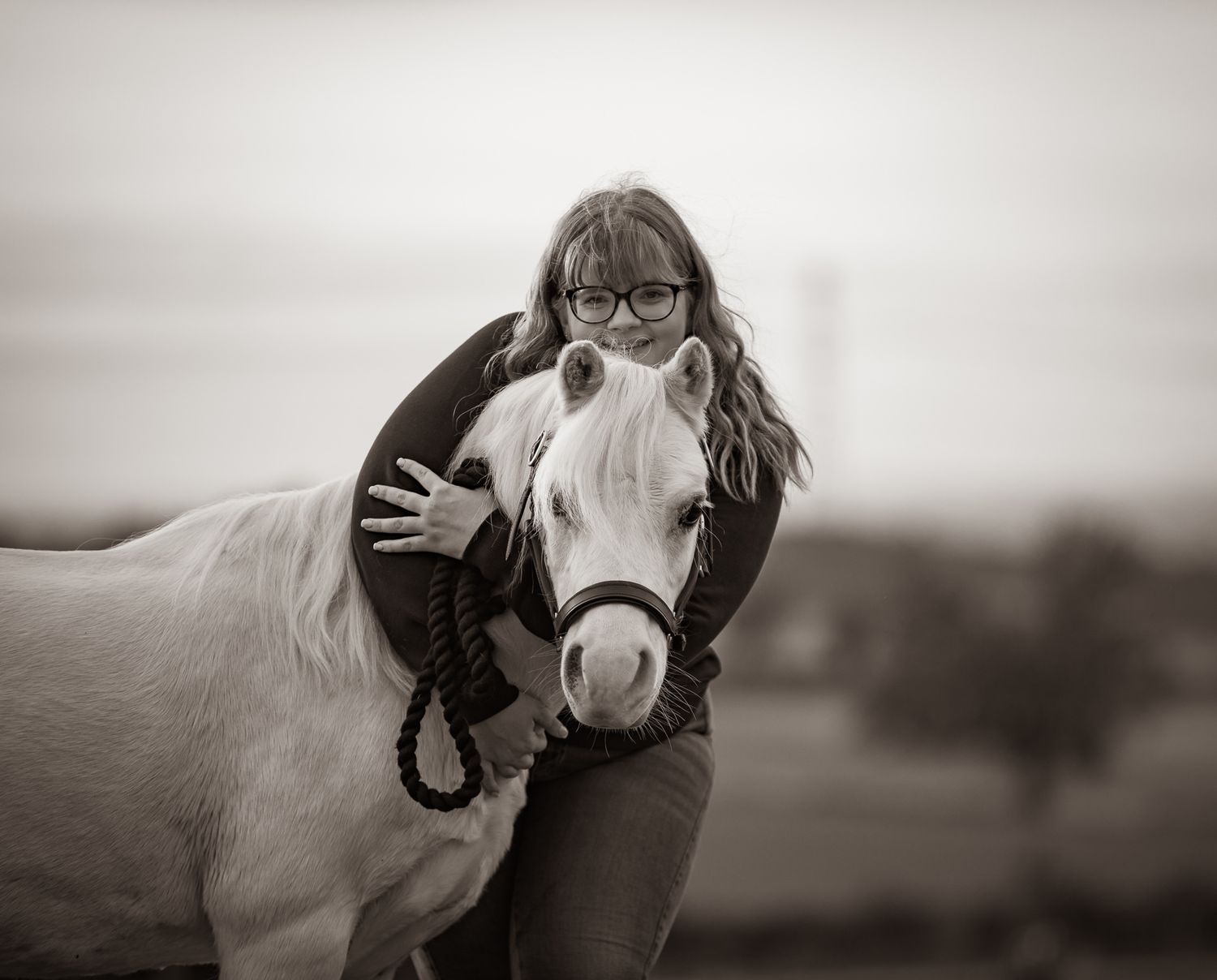 A series of seven photos showing a white horse and rider interacting at a wooden fence in an outdoor setting.