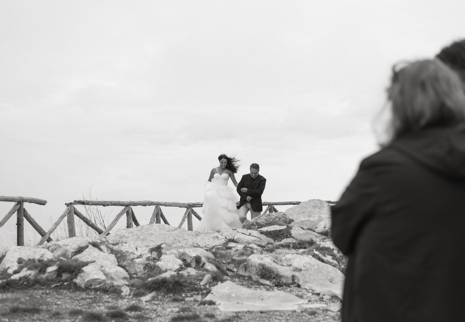 Black and white landscape photograph of a wooden bridge or walkway.