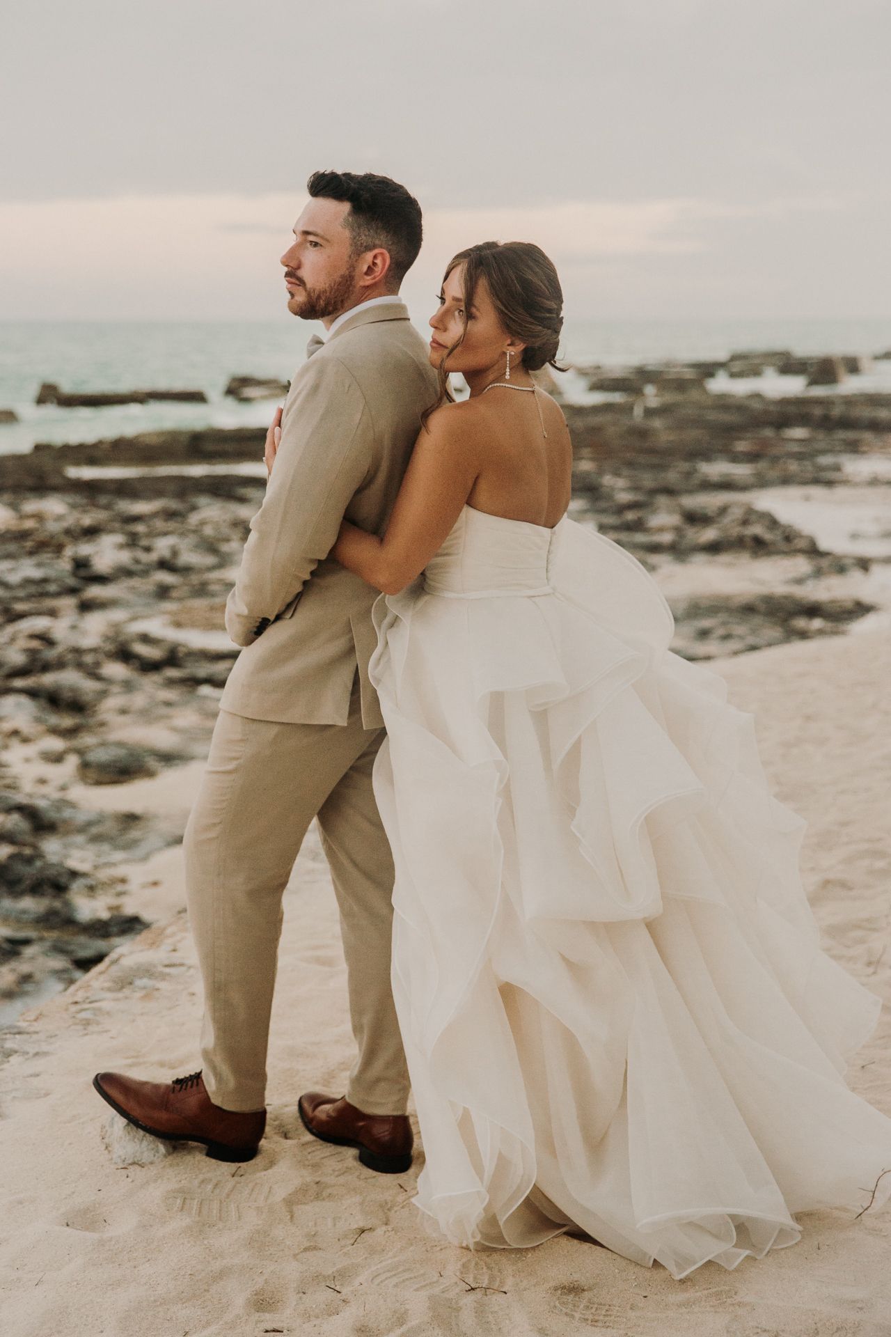 A couple in wedding attire sits together  El Dorado Royale Wedding Photographer
