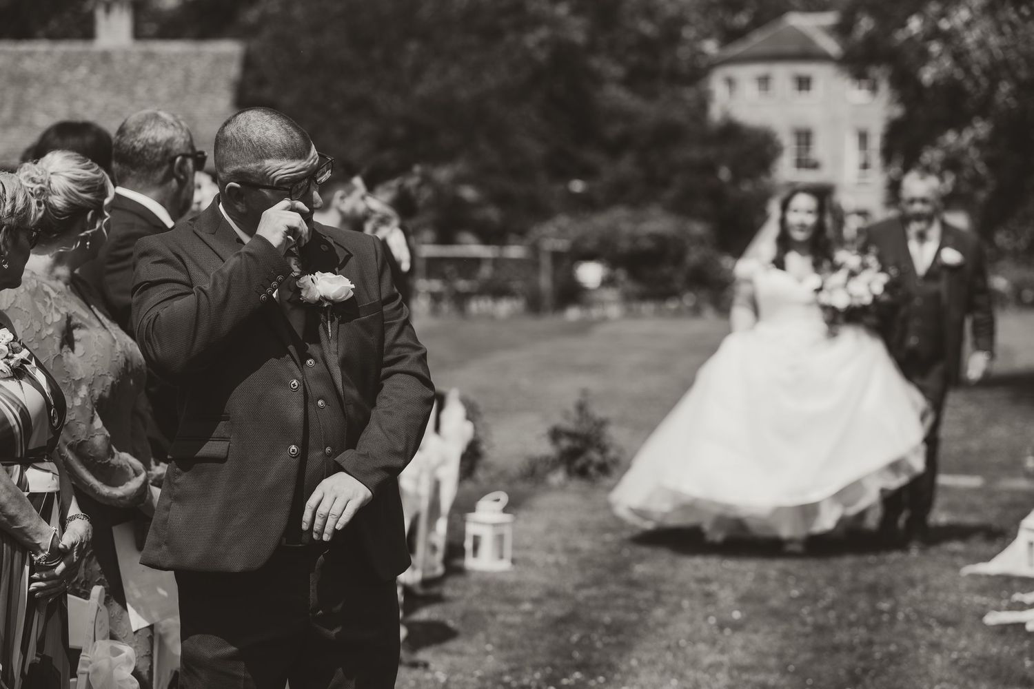 A series of black and white wedding photos showing couples dancing and celebrating outdoors at a garden reception.