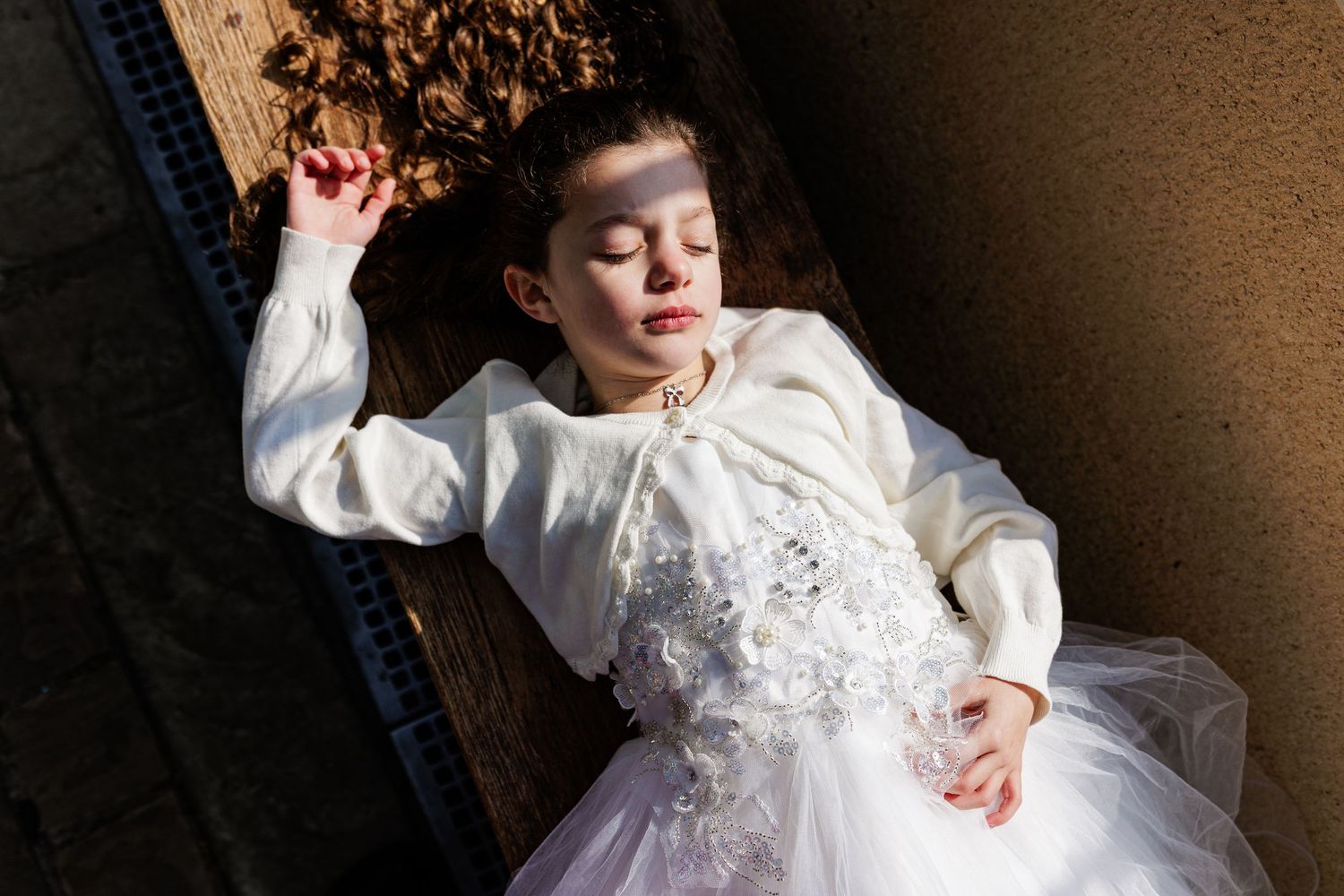 A bride in a white lace wedding dress twirls and spins gracefully in a dramatic dance pose.