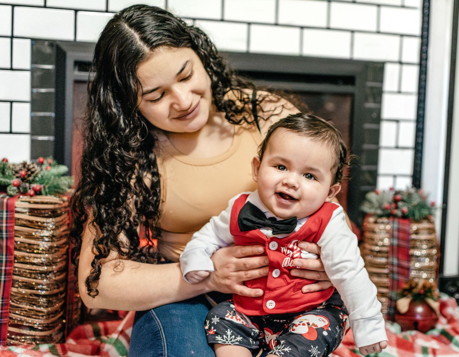 Mother holding her baby during an in-home Christmas photo session in Puyallup