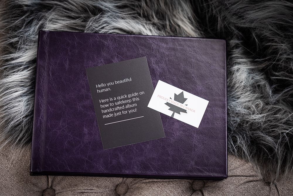Purple leather photo album with care card on a faux fur background.