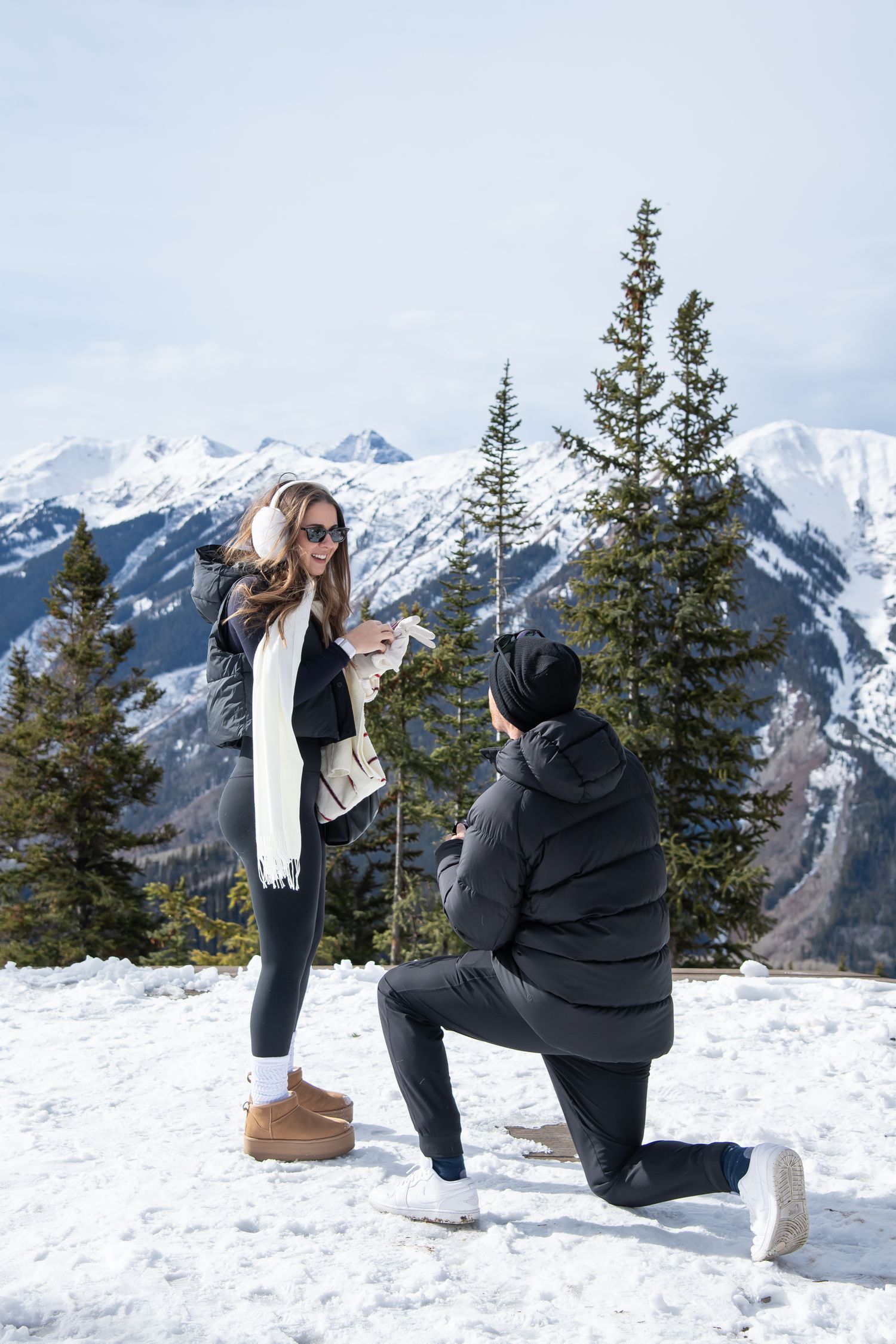 A surprise winter proposal at The Aspen Wedding Deck with snow capped mountains and beautiful winter scenery.