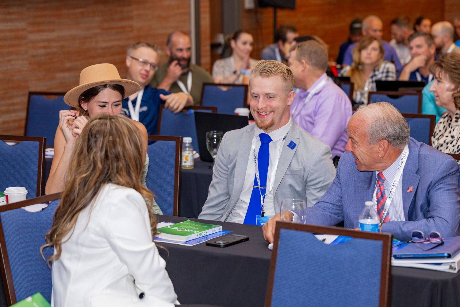 Business professionals engage in discussion at a conference table during a corporate meeting.