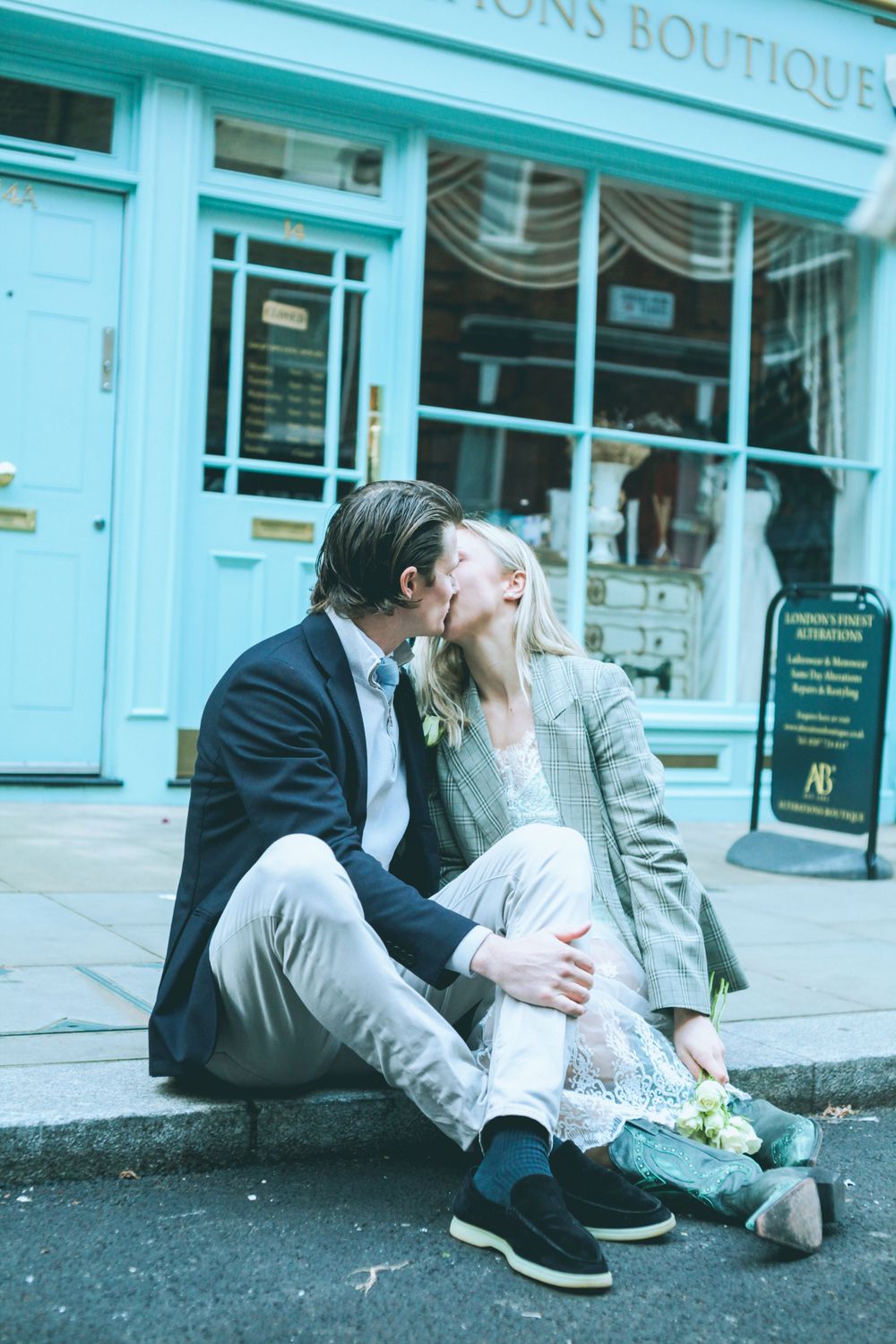 Romantic London engagement session featuring a couple sitting together in a stylish urban setting. Marylebone.