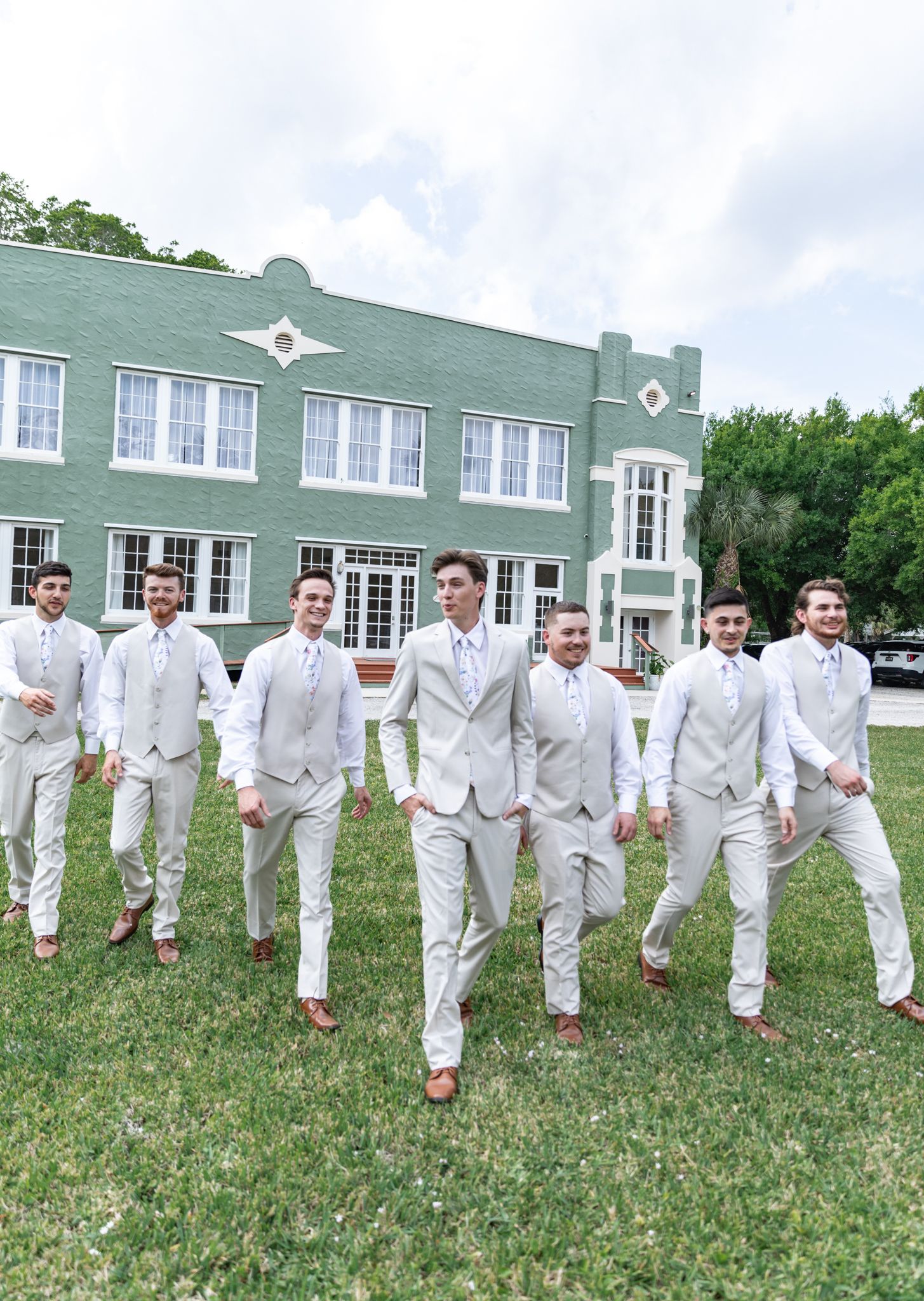 orlando luxury wedding photographer groomsmen walking moment