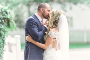 Wealthy couple kiss in wedding attire