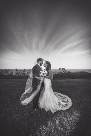 Majestic sky behind bride and groom embracing