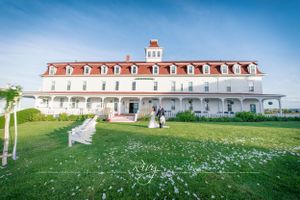 Couple walk in front of mansion on Block Island, Rhode Island