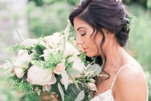 Bride pleasantly smells wedding bouquet