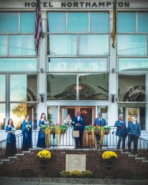 Bride and groom hold each other surrounded by wedding party at Hotel Northampton, CT.