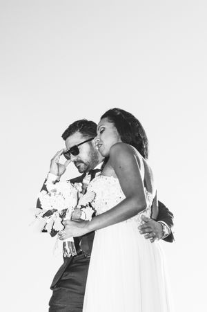 Groom dons sunglasses as he leads his bride