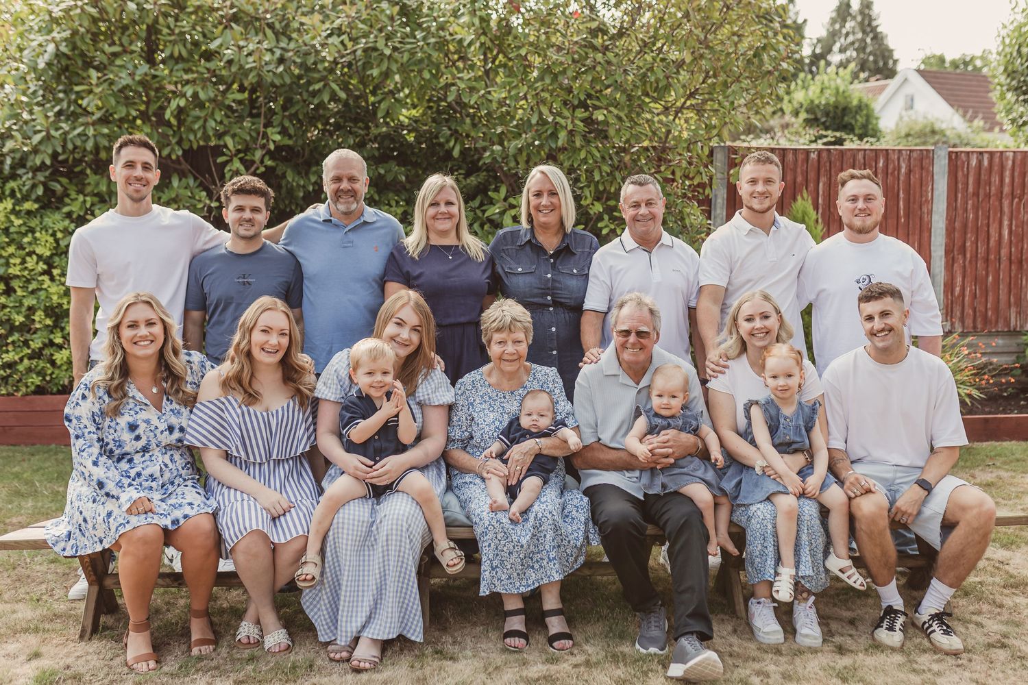 Smiling multi-generational family group spanning four generations, during a Bristol family photoshoot.