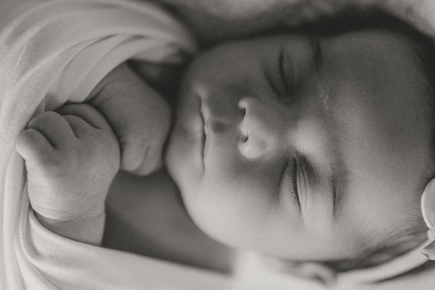 Black and white portrait of sleeping newborn swaddled in soft fabric. Colorado Springs Photographer.