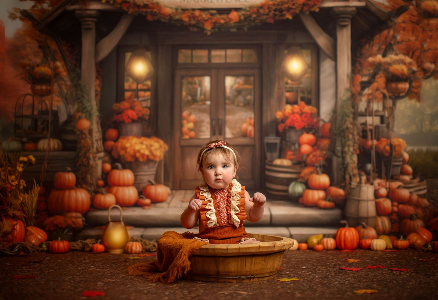 An autumn porch decorated with orange pumpkins, lanterns and fall foliage creates a cozy seasonal setting.