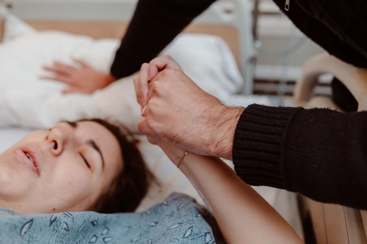 A person receives a relaxing facial massage treatment at a spa with hands applying gentle pressure to their face.