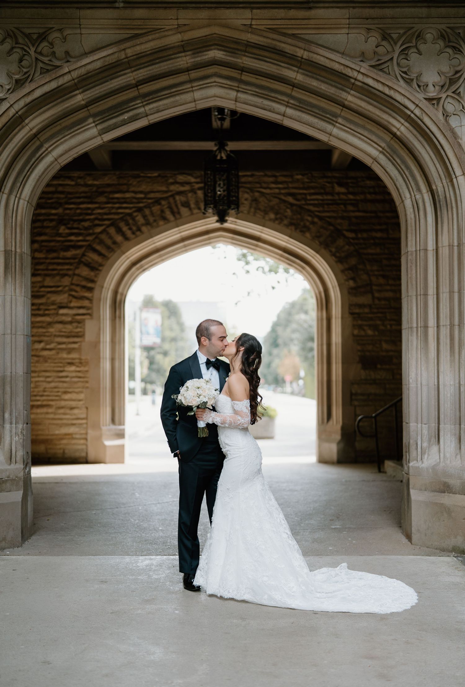 Romantic wedding couple shares tender moments under historic stone archways in sequence of five elegant photos.