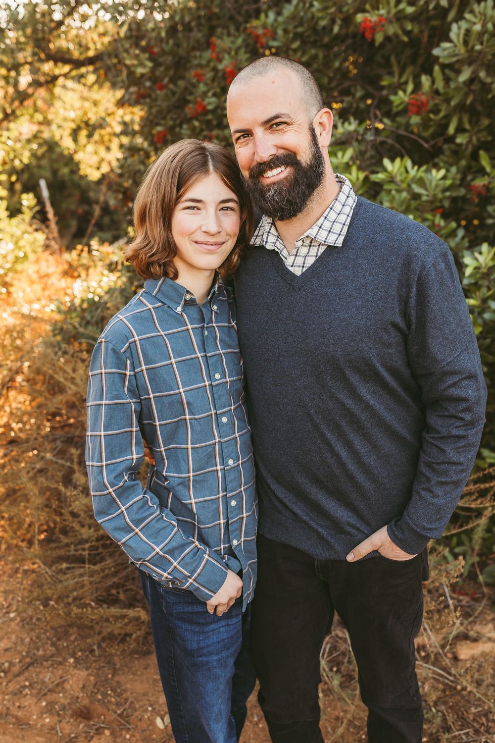 Candid outdoor portrait session showing playful interactions against a natural backdrop.