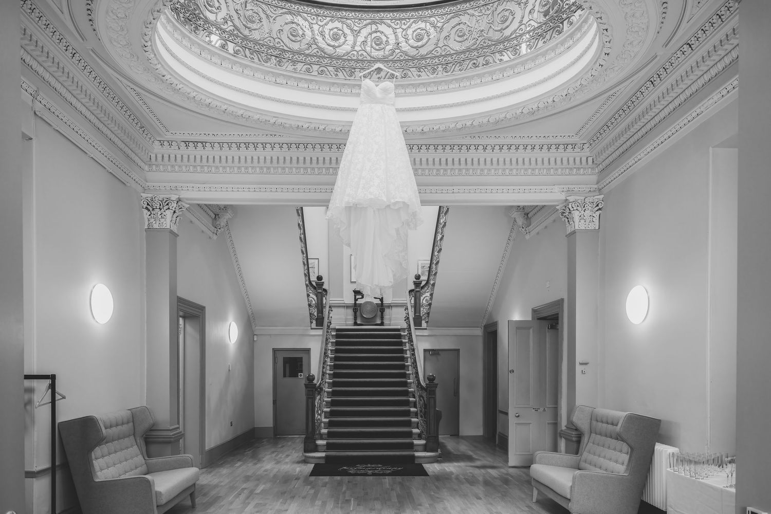 Elegant white marble staircase with ornate railings and decorative moldings in a grand historic building interior.