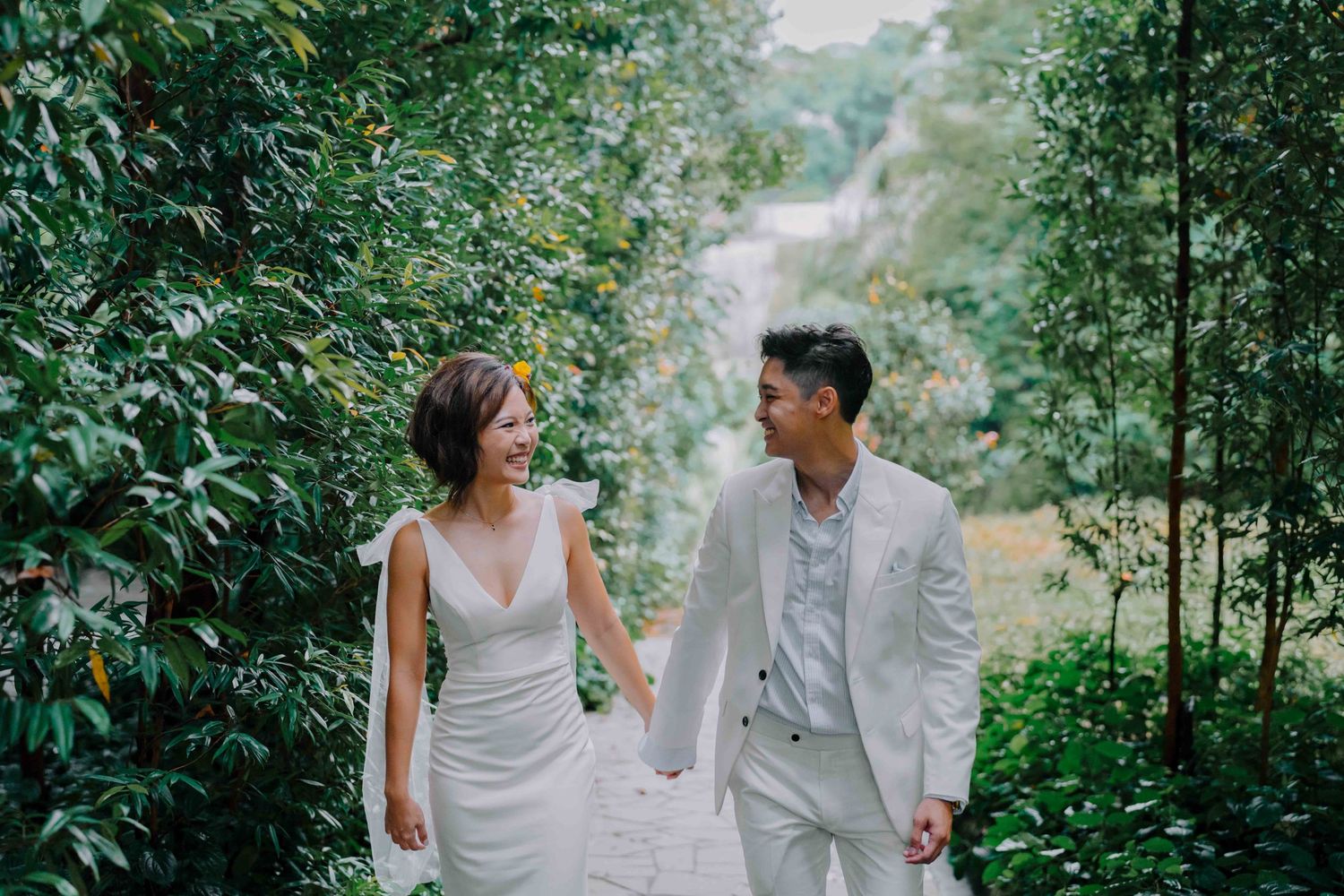 bride and groom holding hands at dempsey singapore