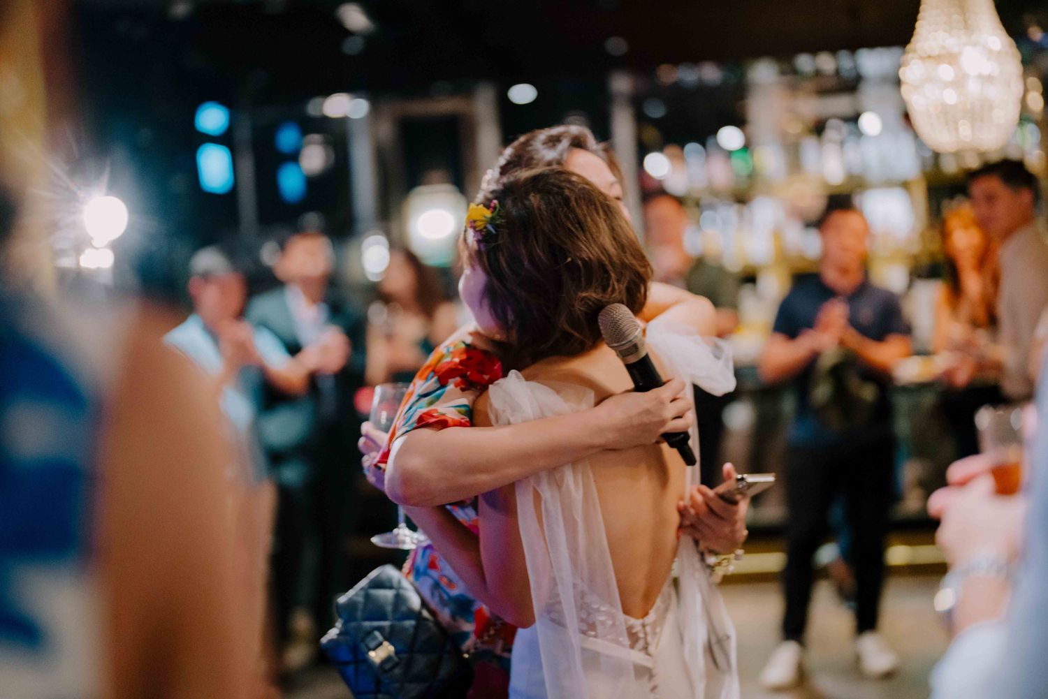 bride hugs her bridesmaid after speeches
